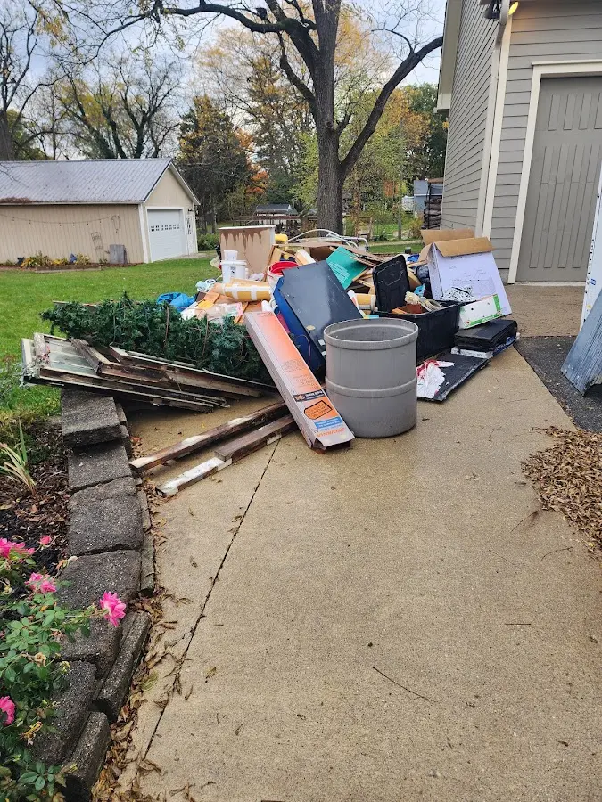 Dumpster being loaded with debris for Roofing Dumpster Rental in Bangor Base